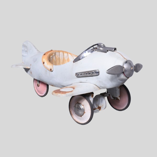 Circa 1940s. A small tin pedal car in the form of an aeroplane.